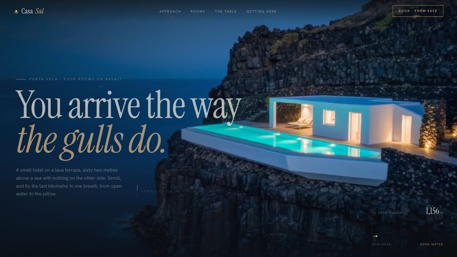 A white cliff hotel with a glowing turquoise infinity pool on black basalt above the sea at blue hour