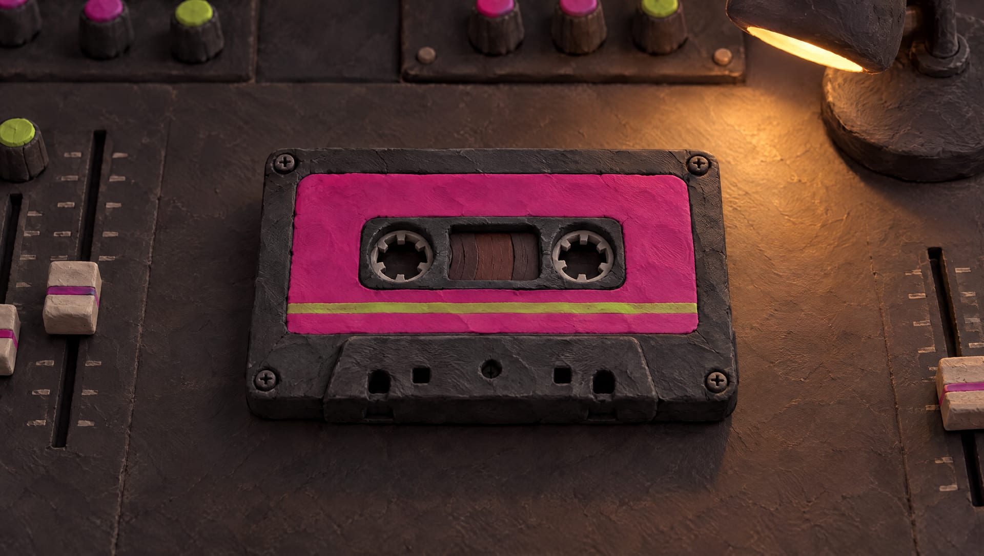 A clay cassette with a magenta label on the mixing desk