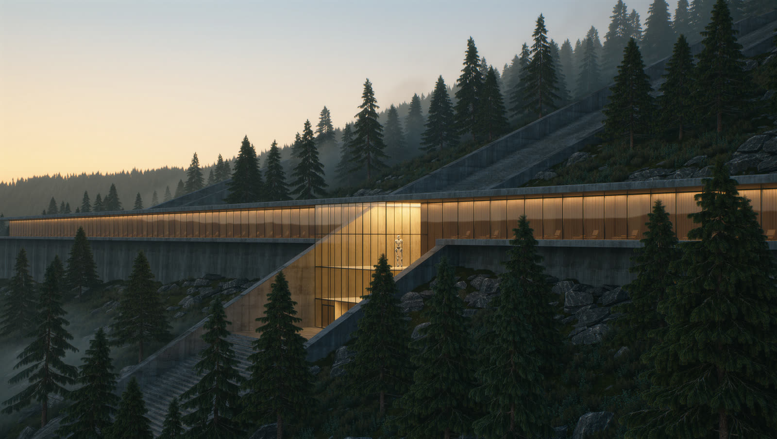 The Kvitberg hall at dawn, a long lit glass building set into a pine hillside