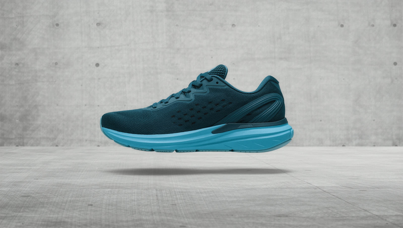 Lattice 09 in Tide, petrol mesh on a bright blue foam midsole, against concrete